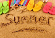 Photo of the word summer written in the sand